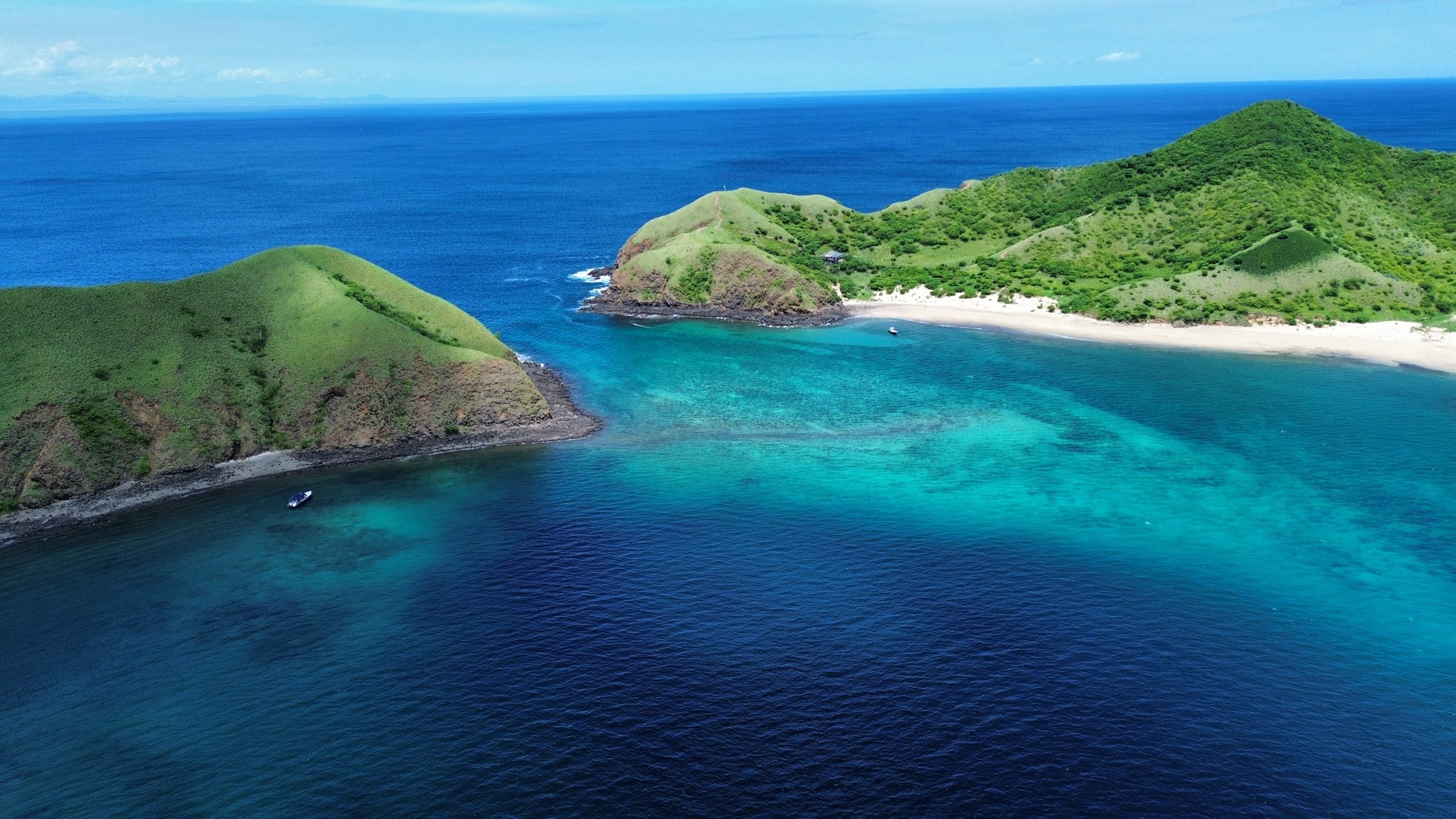Aerial drone view of both Bat Islands with turquoise waters and reef visible, Santa Rosa National Park, Guanacaste, Costa Rica.