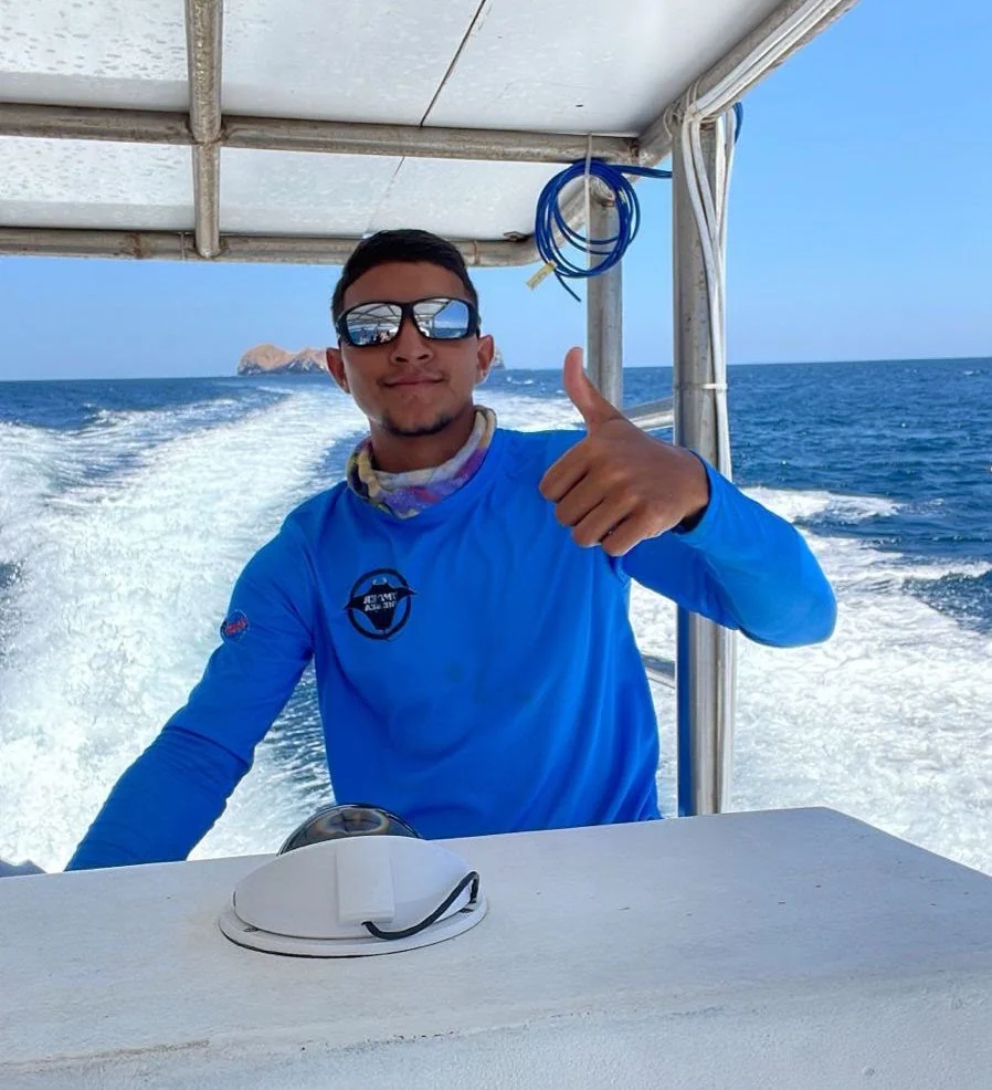 Captain Danny at the helm of Ariel I, heading out to a dive site off Playa Potrero, Costa Rica.