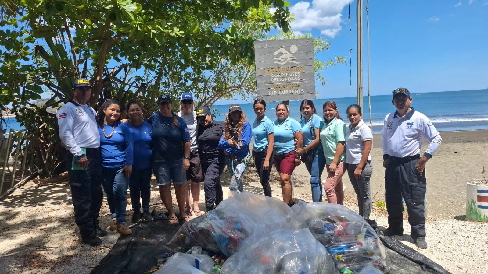 Under The Sea Diving crew and Bandera Azul Ecológica committee members with collected trash at a Playa Potrero beach cleanup
