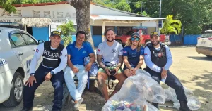 Under The Sea Diving crew, ASADA staff, and Fuerza Pública officers with bags of collected trash after a Playa Potrero beach cleanup, Costa Rica